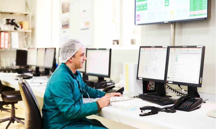 Lab employee in front of a computer screen