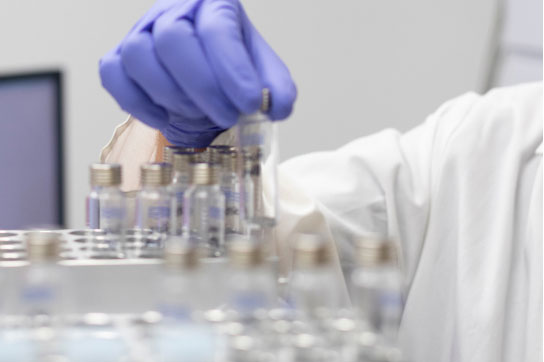 Hand in rubber glow picking up a samples in a lab